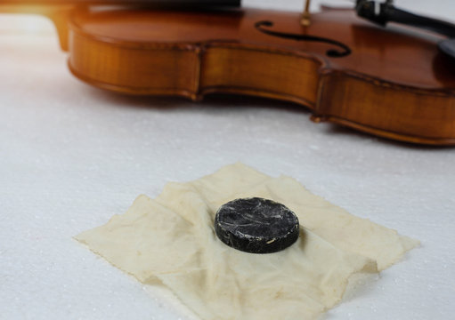 In selective focus of used rosin for violin,put on background,blurry light design background.