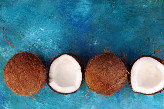 Ripe half cut coconut on a blue background