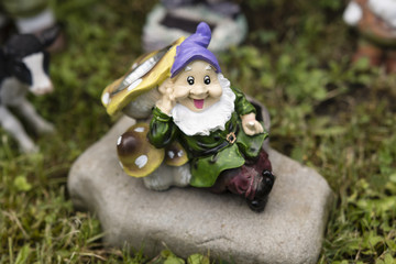 Plastic dwarf with stone mushrooms with light and sensor.