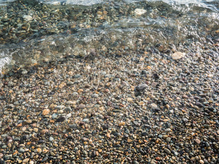 pebble beach and clear surf wave. sea coast