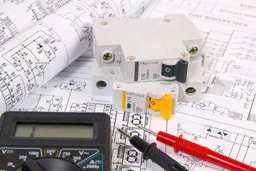 Electrical engineering drawings, modular circuit breaker and digital multimeter. Electrical network...