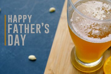 Happy father's day graphic with pint of beer and snacking peanuts in background.  Text for holiday...