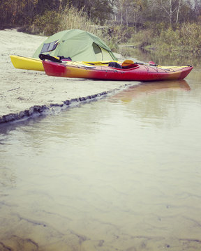 Kayaking on the Lake Concept Photo. Sport Kayak on the Rocky Lake Shore. Close Up Photo.