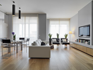 modern living room interior  in the foreground the leather sofa and the glass dining table the floor is made of wood