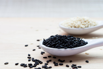 The black and white sesame on the wooden table.