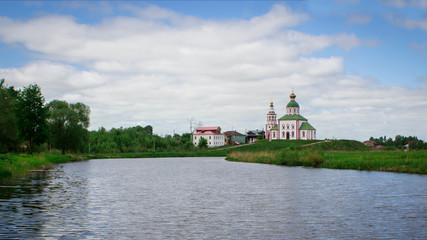 Landscape orthodox church in Russian village on the river.