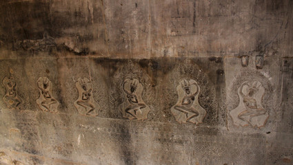 Carving Buddha figure close up on the walls of the ancient Angkor Wat Temple in the Angkor Area, near Siem Reap, Cambodia, Asia. Asian Buddhist monastery from the 12th century. 