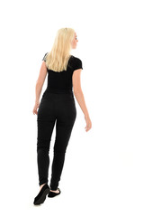 full length portrait of blonde girl wearing black clothing, isolated on white background.