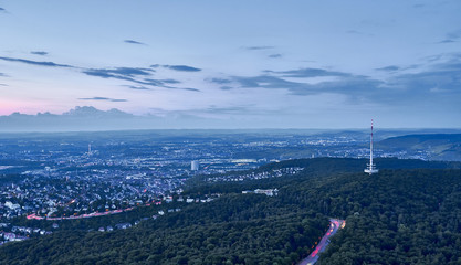 Night falls over Stuttgart City in Germany / Turning on the lights in the city