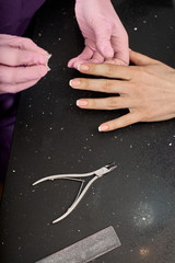 Obraz na płótnie Canvas Woman in nail salon doing classical french manicure