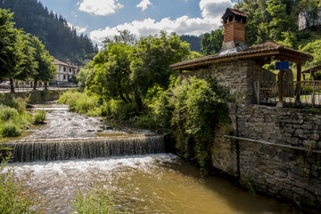 Fototapeta na wymiar The river of the village of Shiroka Laka. It is situated in the valley of the Shirokoloshka river in the Shirokata Luka locality, between the Perelik part of the Rhodopes and the Chernatitsa ridge.