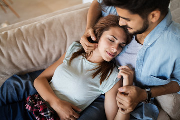 Pretty young girl lying on lap of her boyfriend