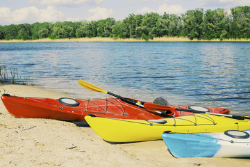 Kayaking on the Lake Concept Photo. Sport Kayak on the Rocky Lake Shore. Close Up Photo.