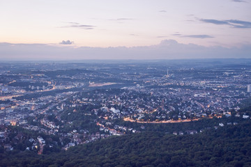 Fototapeta na wymiar Night falls over Stuttgart City in Germany / Turning on the lights in the city