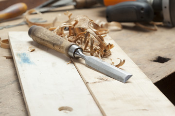 chisel an sawdust on wooden board.copy space