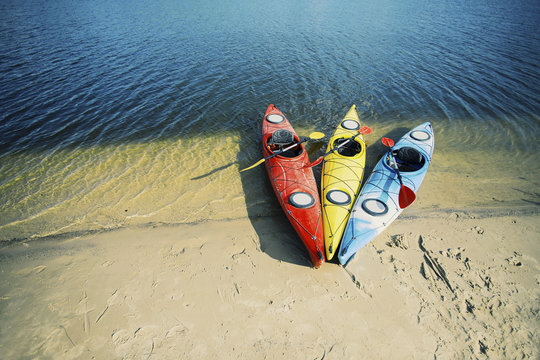 Kayaking on the Lake Concept Photo. Sport Kayak on the Rocky Lake Shore. Close Up Photo.
