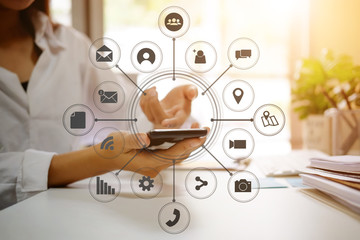 Business woman analysis data in mobile smartphone with virtual icon.