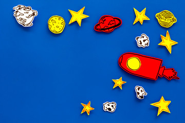Space tourism concept. Drawn rocket or spaceship near stars, planets, asteroids on blue background...