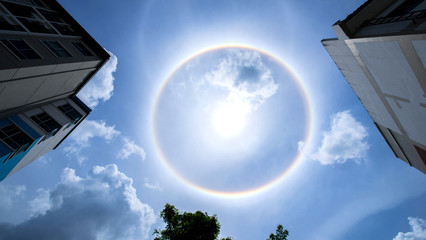 Fototapeta na wymiar sun corona rainbow clouds and blue sky background , Circumscribed halo