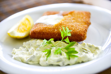 fried  cheese, mayonnaise, parsley ,lemon, plate