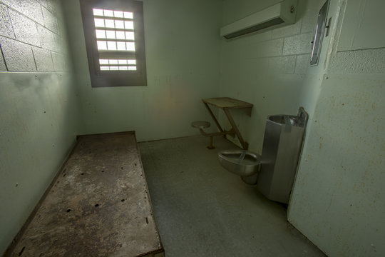Metal bed inside solitary confinement cell