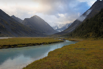 Naklejka na ściany i meble Ak-Kem mountain river with yellow grassy banks. Altai, Russia