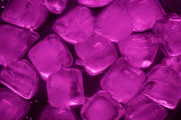 A pile of ice cubes in purple on a reflecting table
