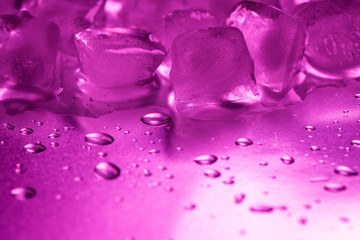 A pile of ice cubes in purple on a reflecting table