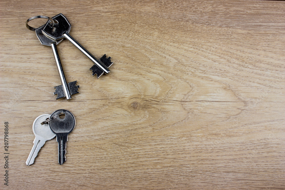 Poster many keys on wooden background. empty space for text