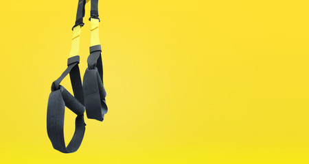 Training strap equipment. Black strap functional training equipment on grey background. Sport accessories. Fitness and Gym workout items for Healthy. Advertising banner