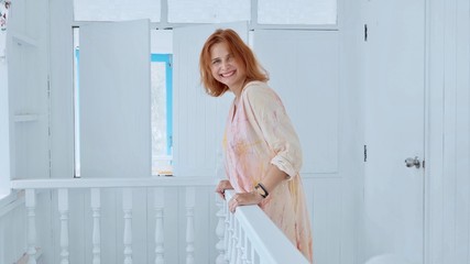 Charming happy young woman smiling and looking at camera