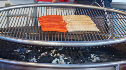 Grilled meat sausages outdoors on food festival in Hamburg, Germany. Grilled sausages take away. Traditional German food.