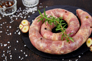 Raw spiral pork sausages
