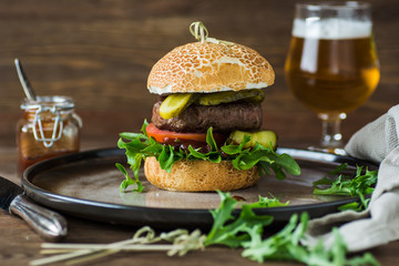 Beef burger with tomatoe, cucumber and salad