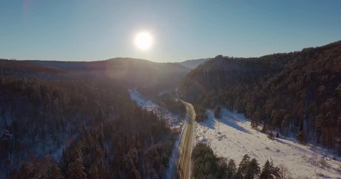 Winding road in winter forest in Ural Mountains. Russia, Bashkortostan aerial photography