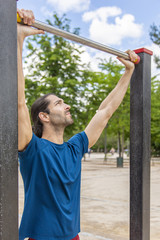 Young man making Pull-up strength training exercise