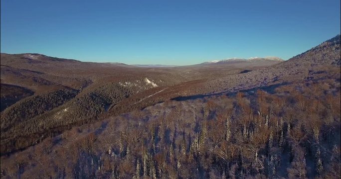 Winding road in winter forest in Ural Mountains. Russia, Bashkortostan aerial photography