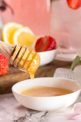 Honey dipper, strawberry and cold delicious drink