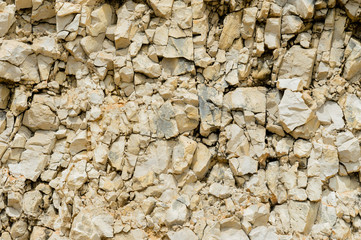 Textured stone background Rubble ballast in natural form in the rock wall