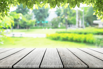 Empty wooden table with party in garden background blurred.