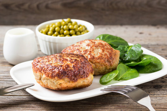 Homemade cutlets with a salad on a plate in a rustic style.