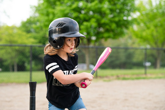 Girl swinging a bat