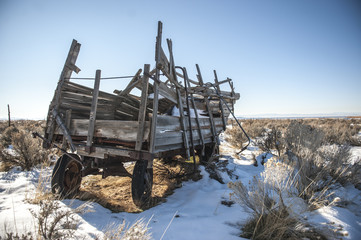 Snowy old wooden wagon on abandoned dairy farm near Fillmore, Utah