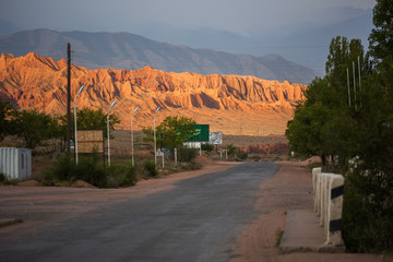 The road to the rocks, brightly lit at dawn. Republic Of Kyrgyzstan.