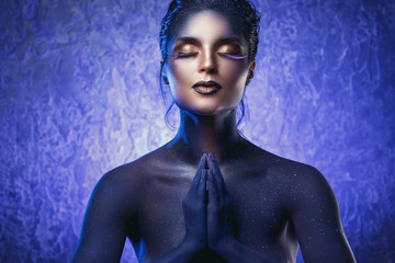 Beautiful woman with a creative makeup and body-art