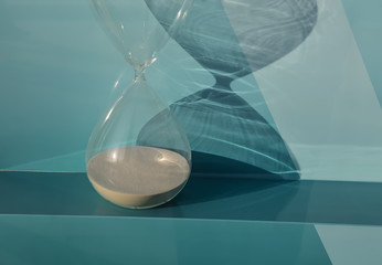 Hourglass as time passing concept for running out of time.