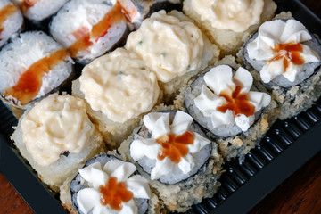 Japanese rolls in a container for delivery.