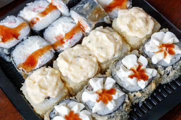 Japanese rolls in a container for delivery.