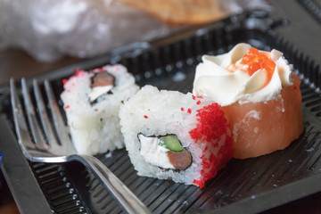 not eaten sushi in a container with a fork