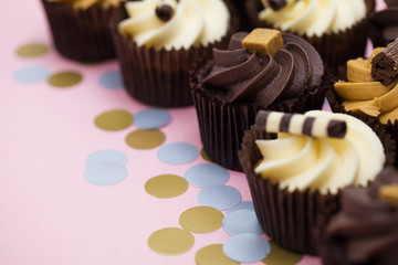 Cupcakes decorated with chocolate,caramel and vanilla icing